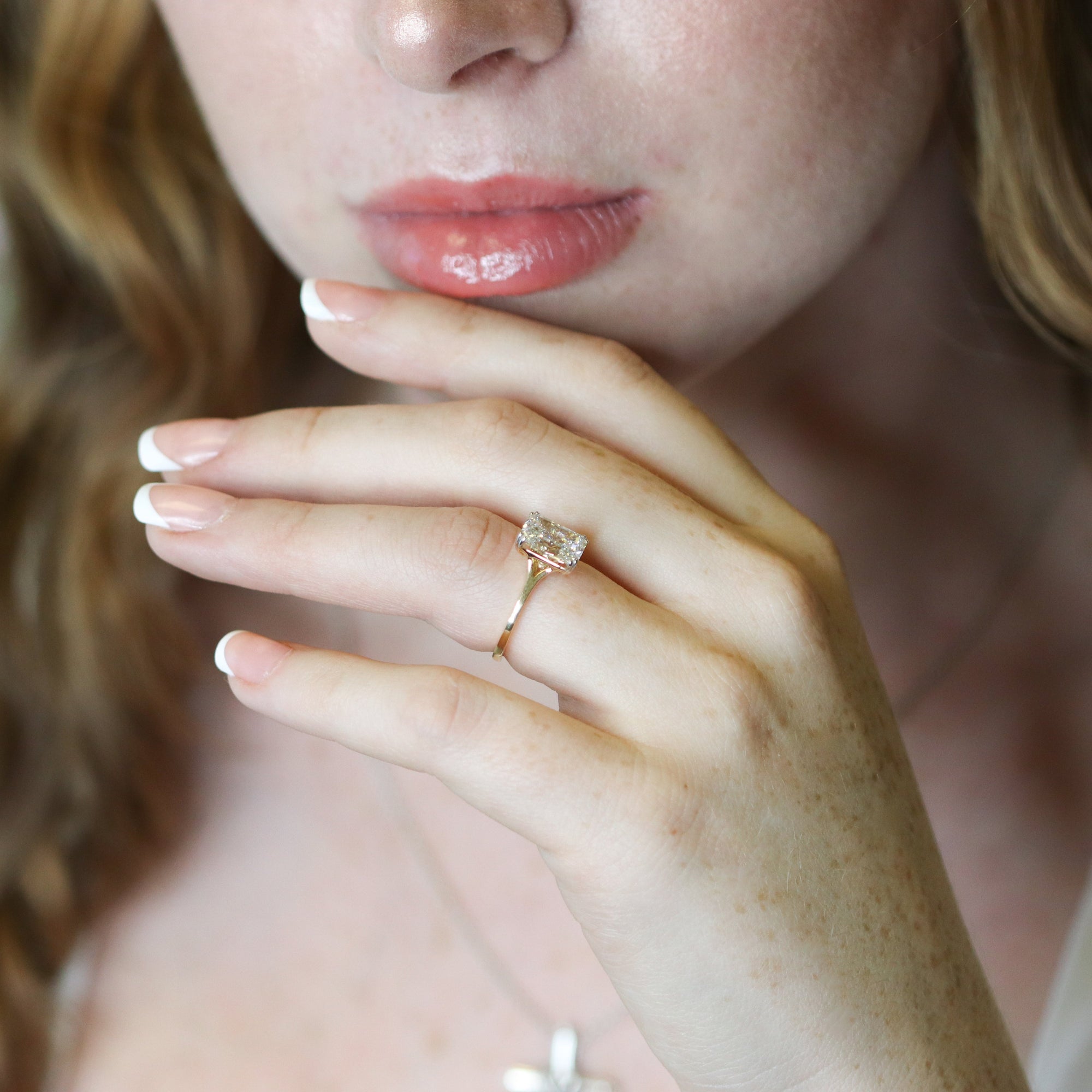 Close-up of a woman's hand with a ring, blurred background