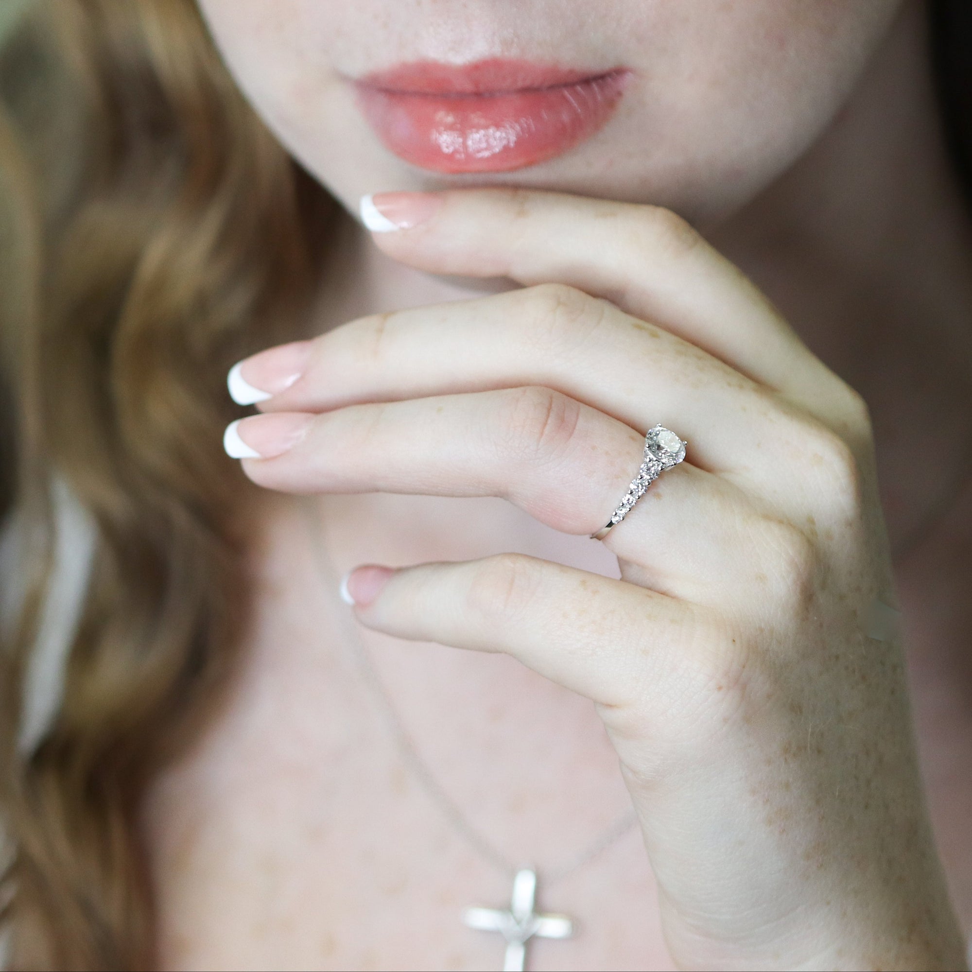 Close-up of a woman wearing a ring with a blurred background