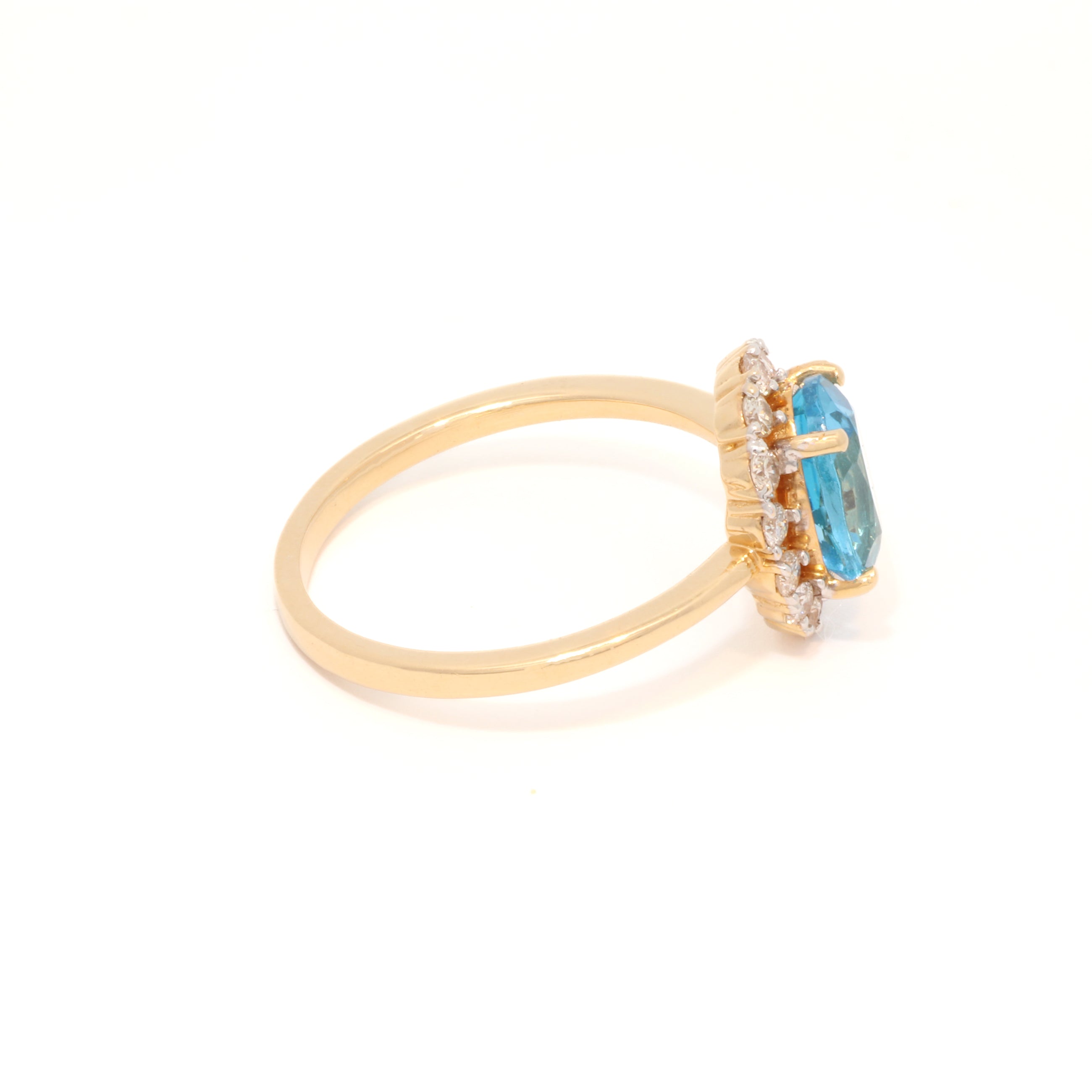 Gold ring with a blue gemstone on a white background