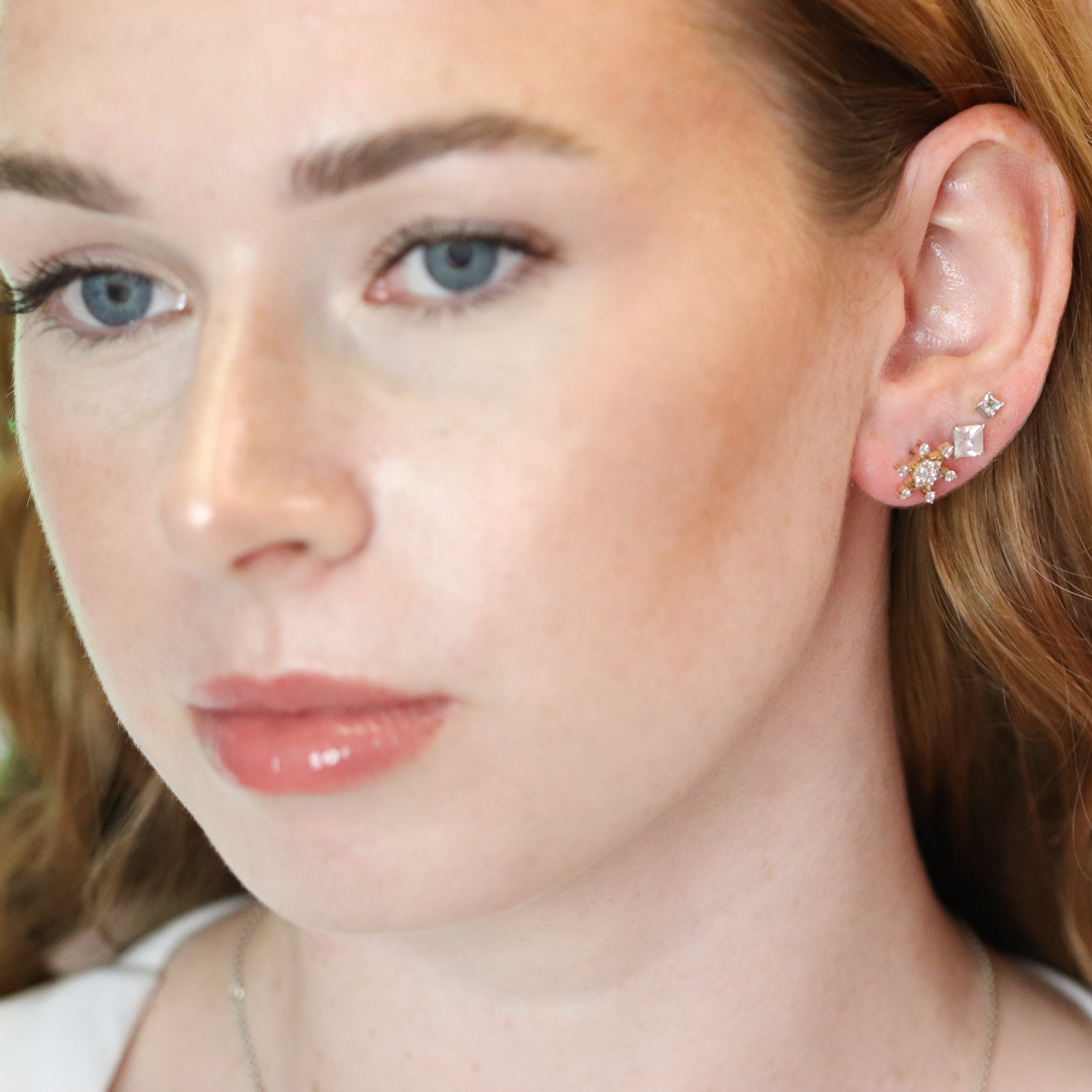 Diamond Studs in Yellow Gold on Ear.