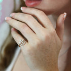 Close-up of a hand wearing a ring with a blurred background