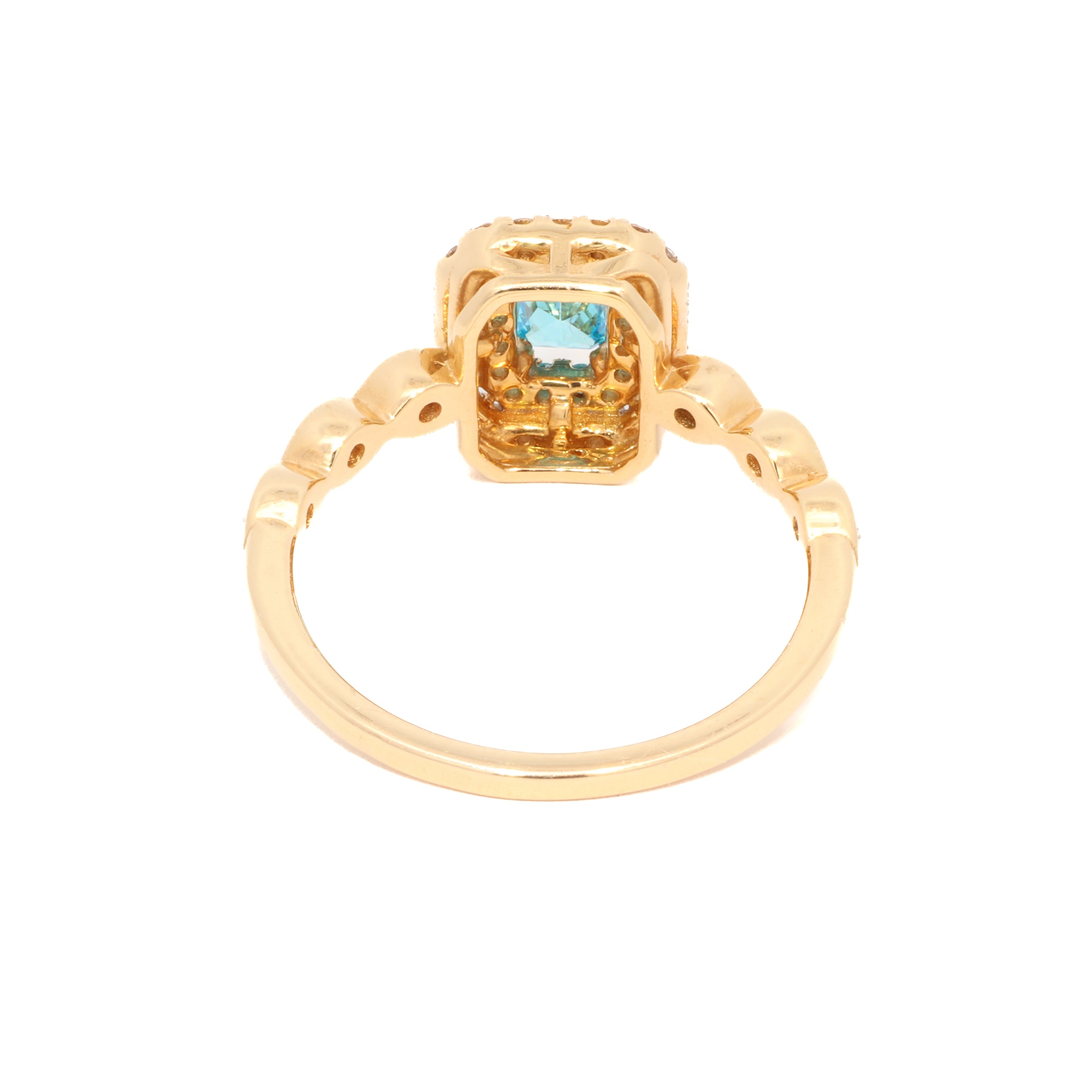 Gold ring with a blue gemstone on a white background