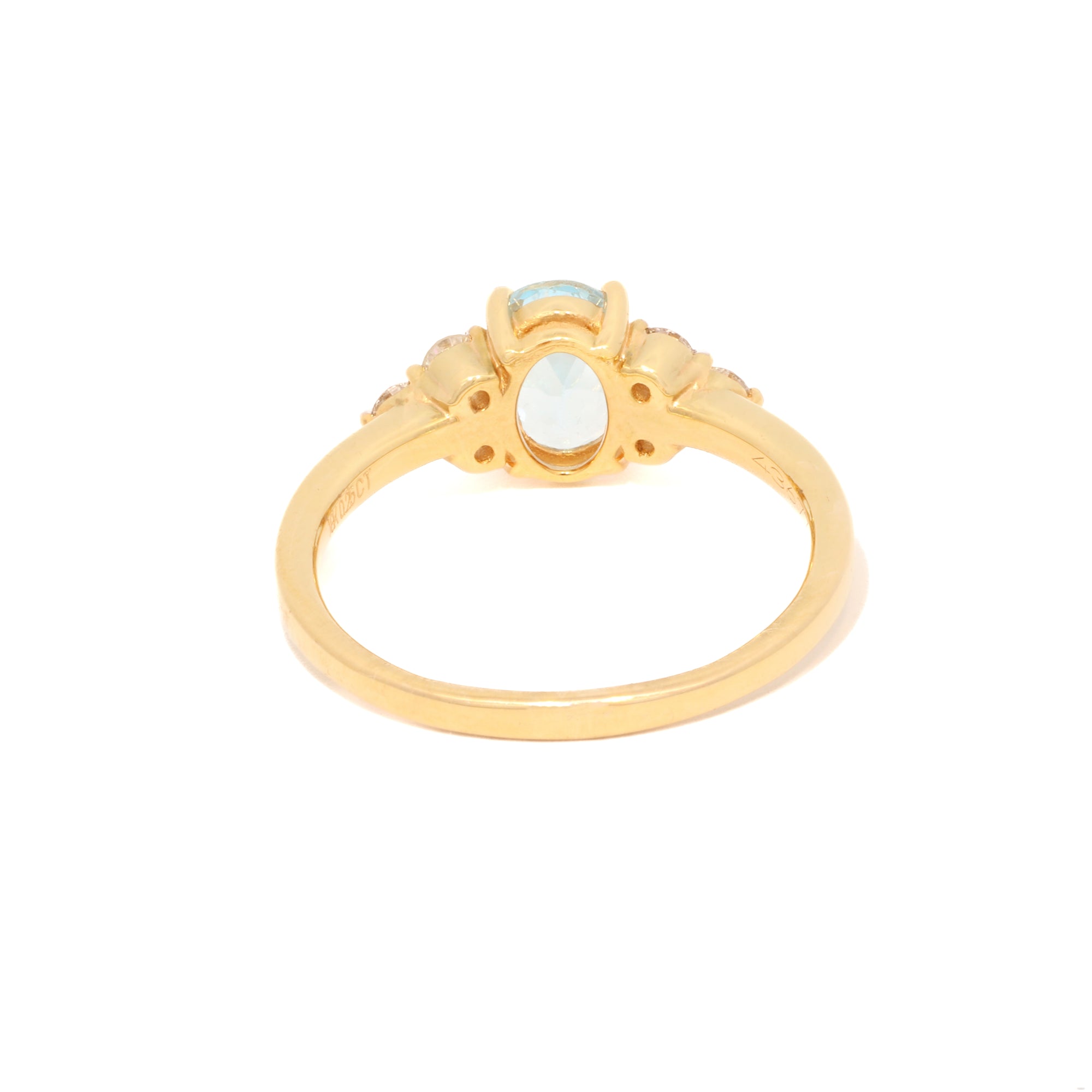 Gold ring with a central gemstone on a white background