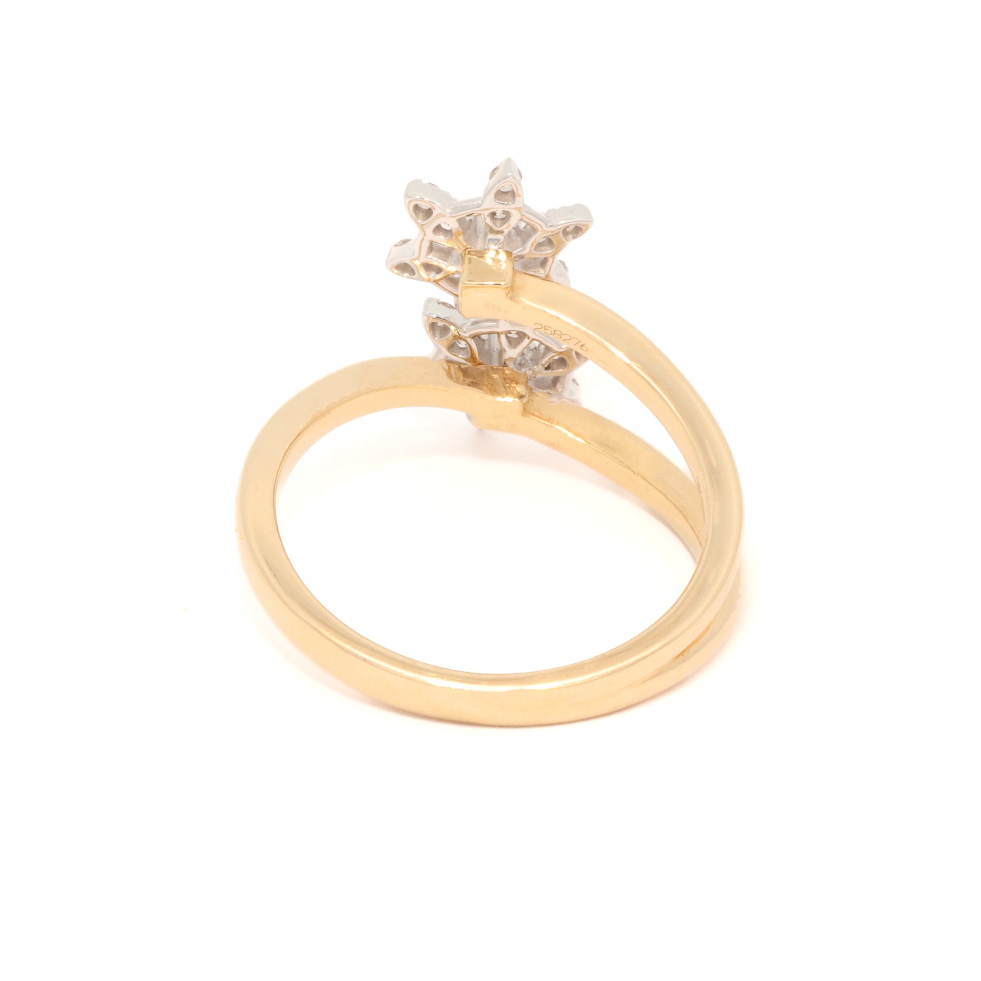 Gold ring with a star-shaped diamond on a white background
