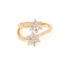 Gold ring with star-shaped diamond designs on a white background
