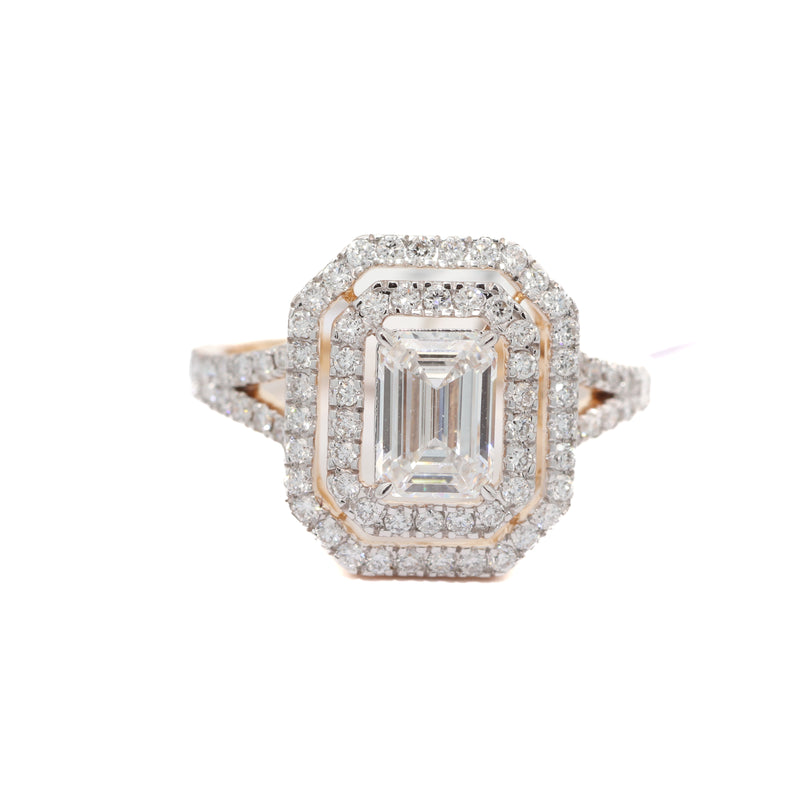 Diamond ring with a rectangular center stone on a white background