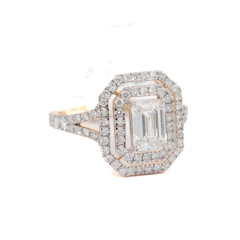 Diamond ring with emerald-cut center stone and halo on a white background