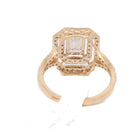 Yellow gold ring with a diamond on a white background