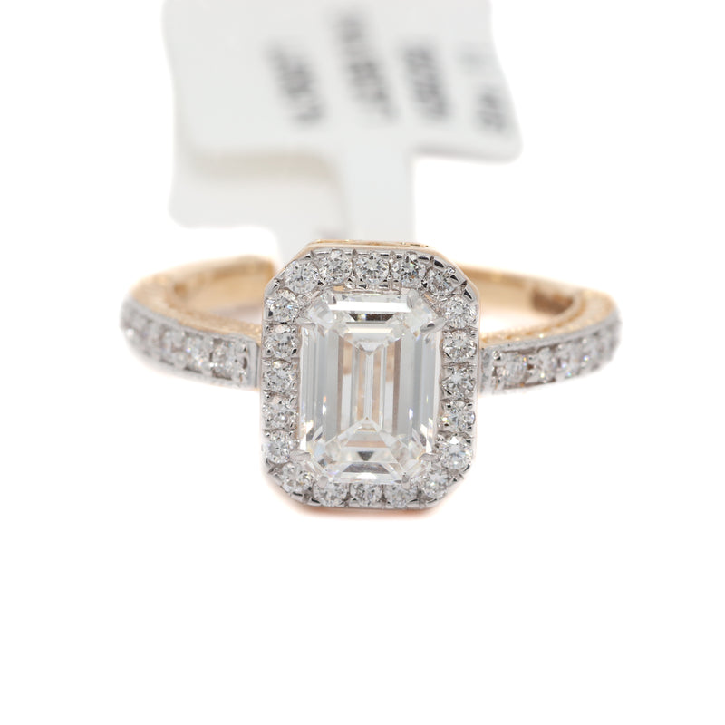 Diamond ring with emerald-cut center stone on a white background