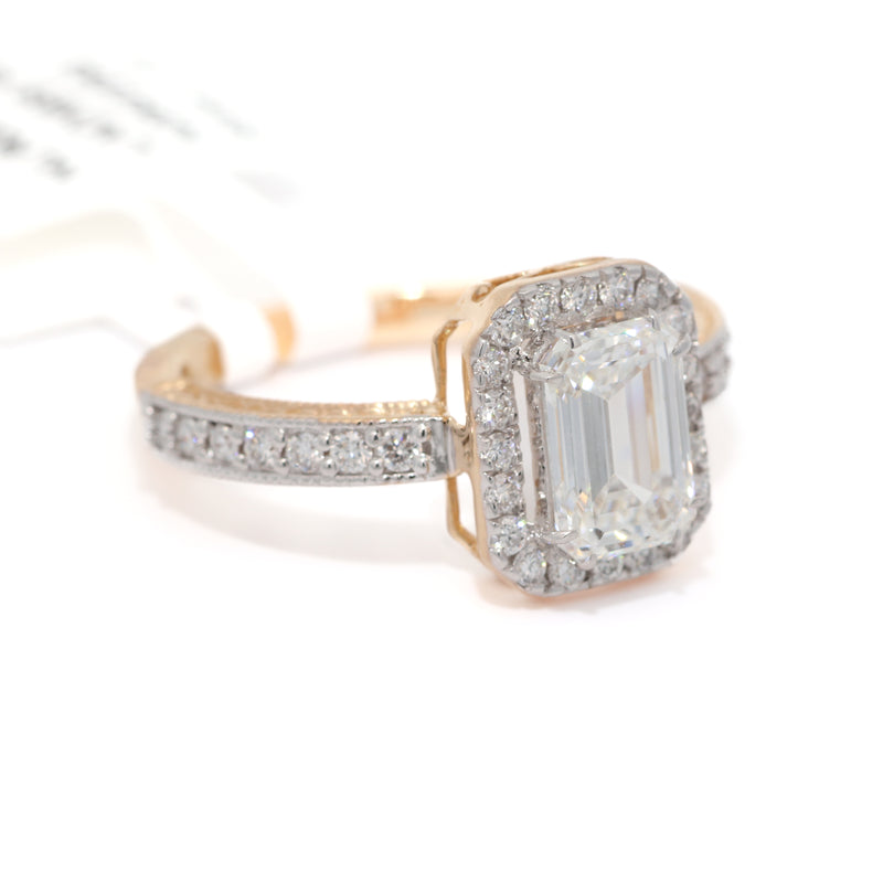 Diamond ring with a central emerald-cut gemstone and smaller diamonds on a white background