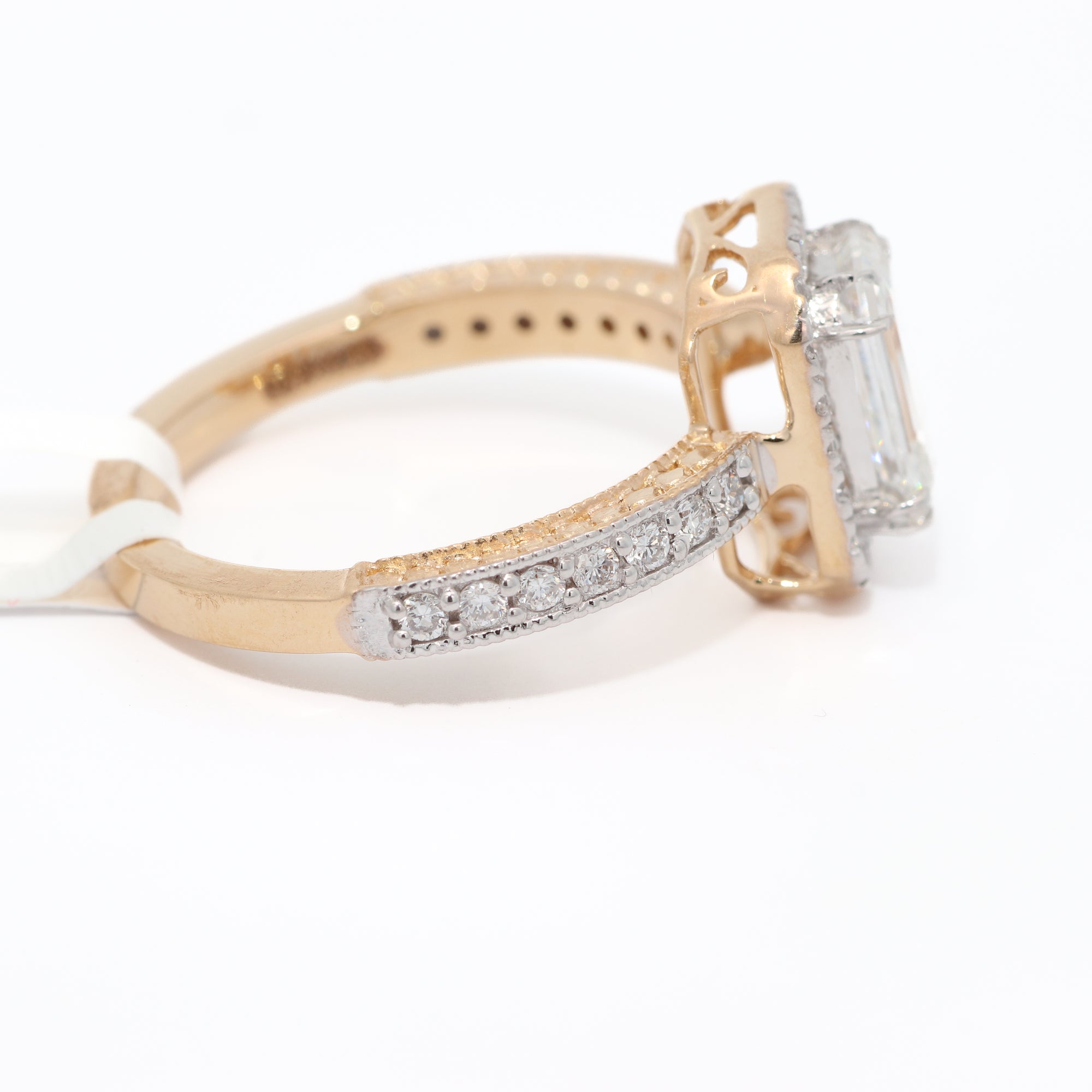 Gold ring with diamond accents on a white background