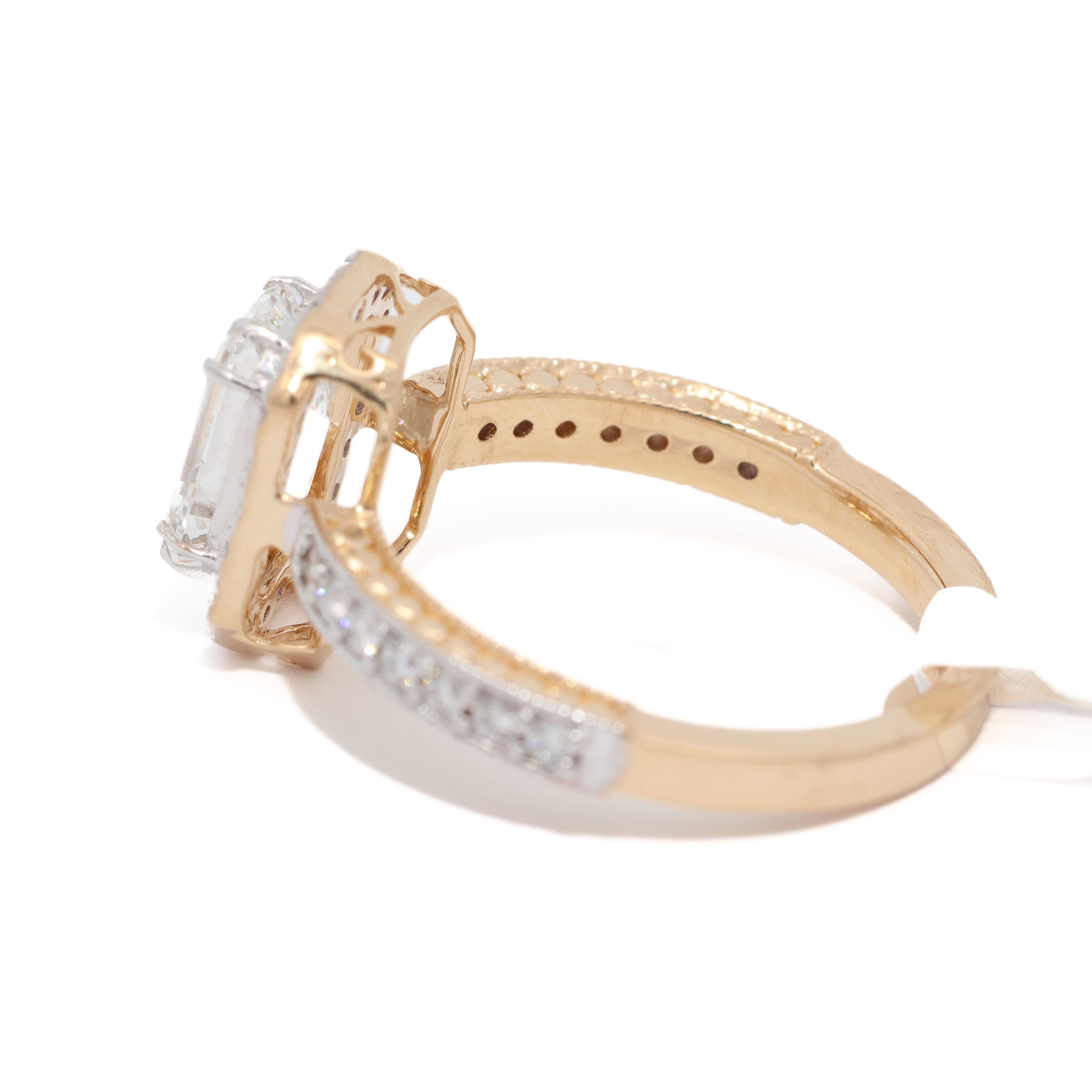 Gold ring with diamond accents on a white background
