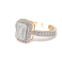 Gold ring with a large emerald-cut diamond and smaller diamonds on a white background