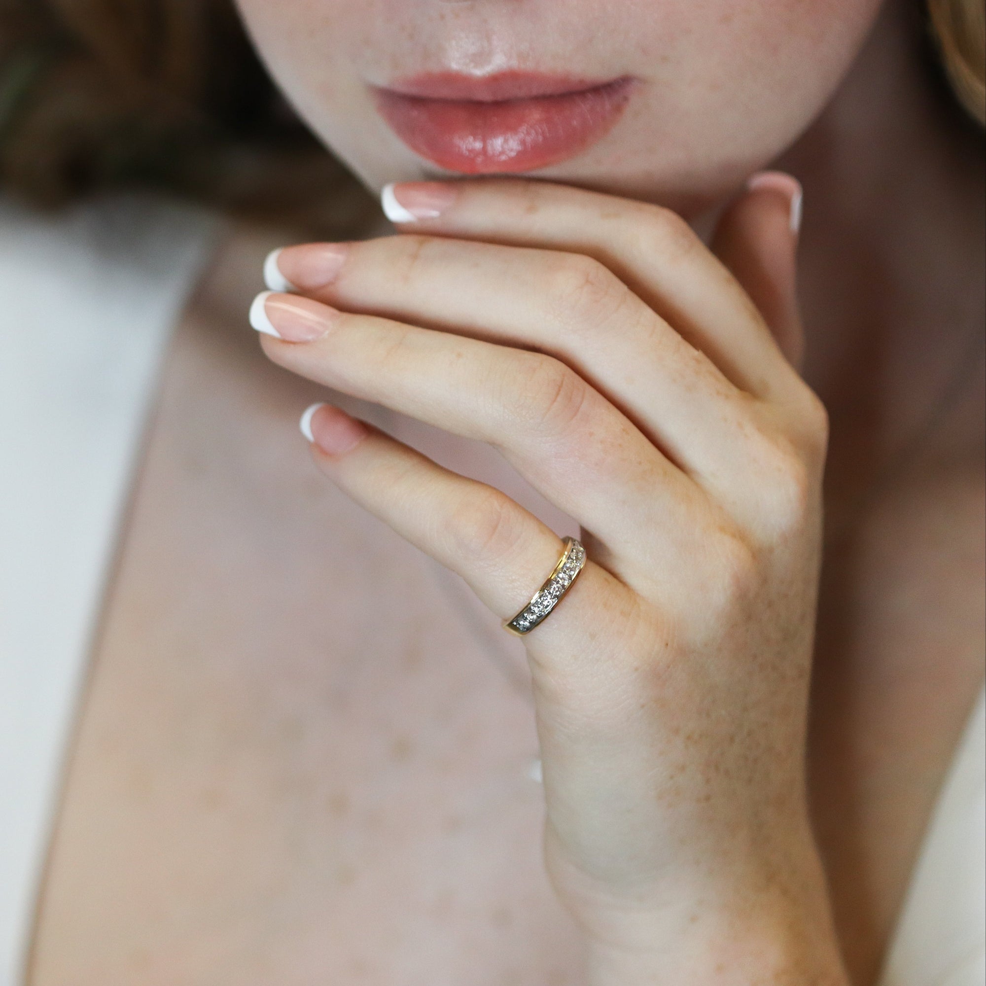 Close-up of a person wearing a ring with a blurred background