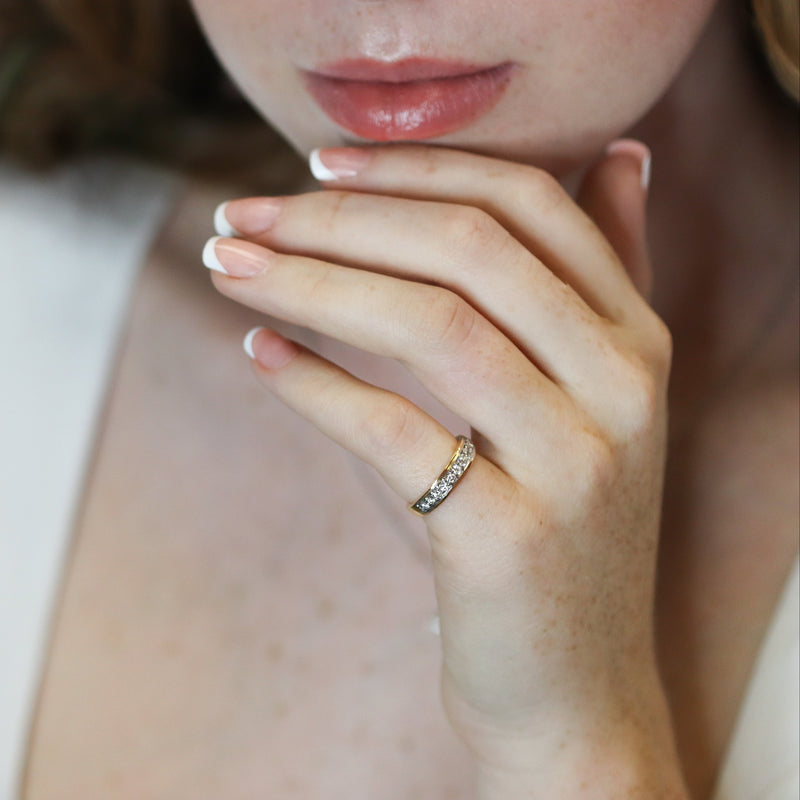 Close-up of a person wearing a ring with a blurred background