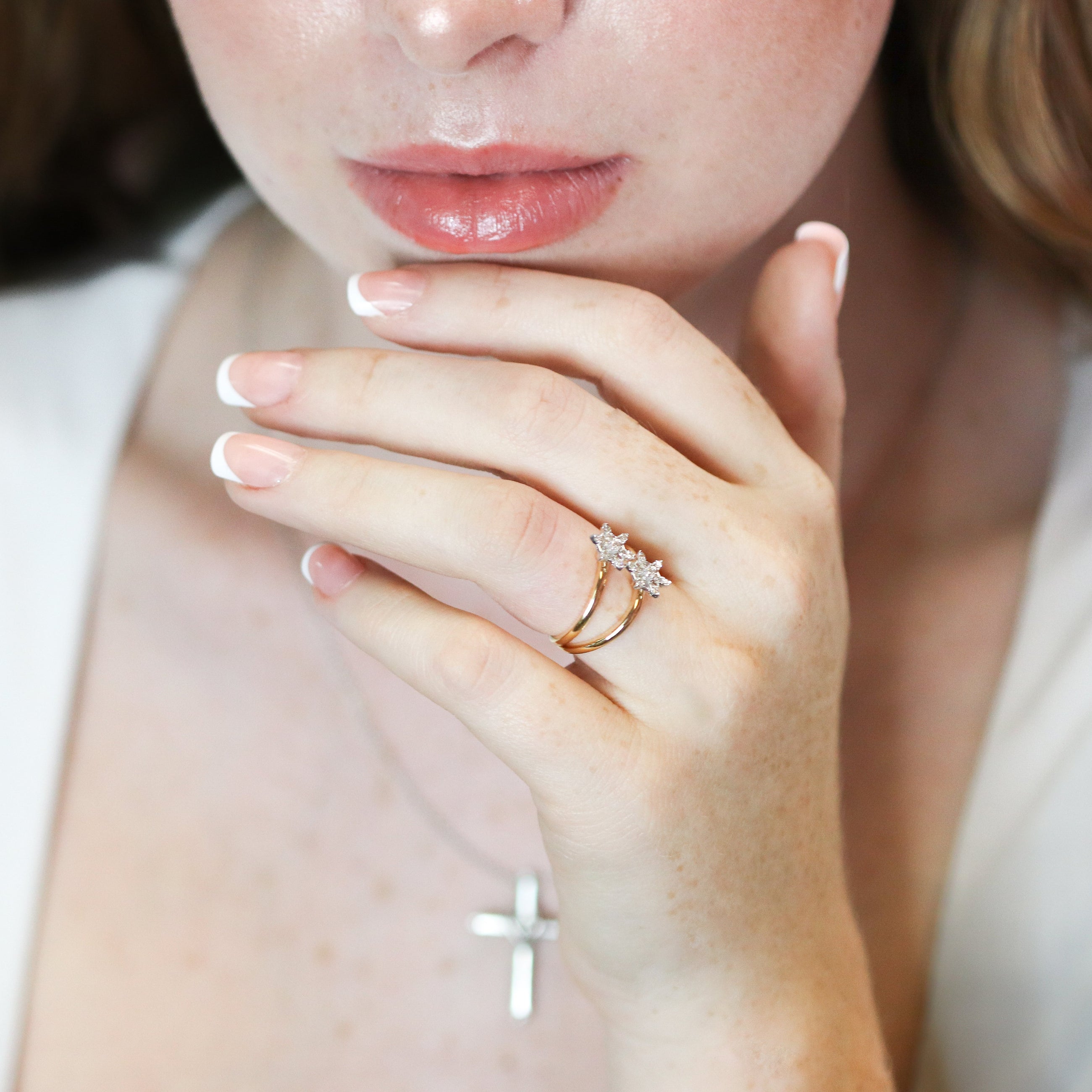 Close-up of a person wearing a diamond ring.