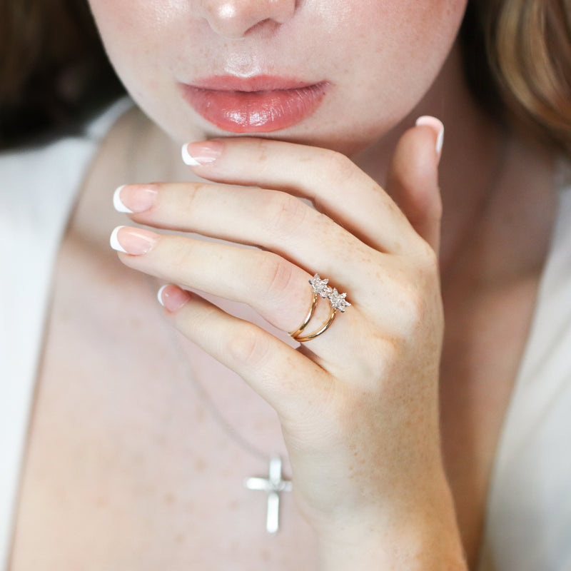 Close-up of a person wearing a diamond ring.