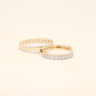 Two gold huggies with diamond accents.