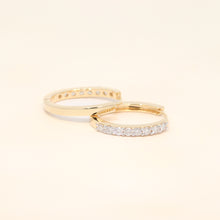 Two gold huggies with diamond accents.