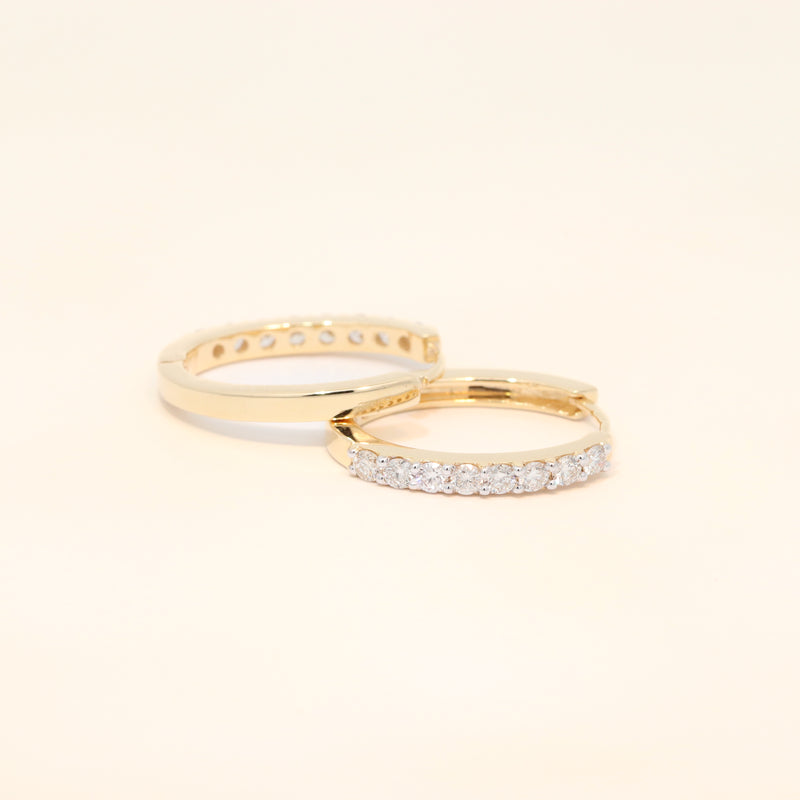 Two gold huggies with diamond accents.