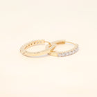 Two gold huggies with natural diamonds.