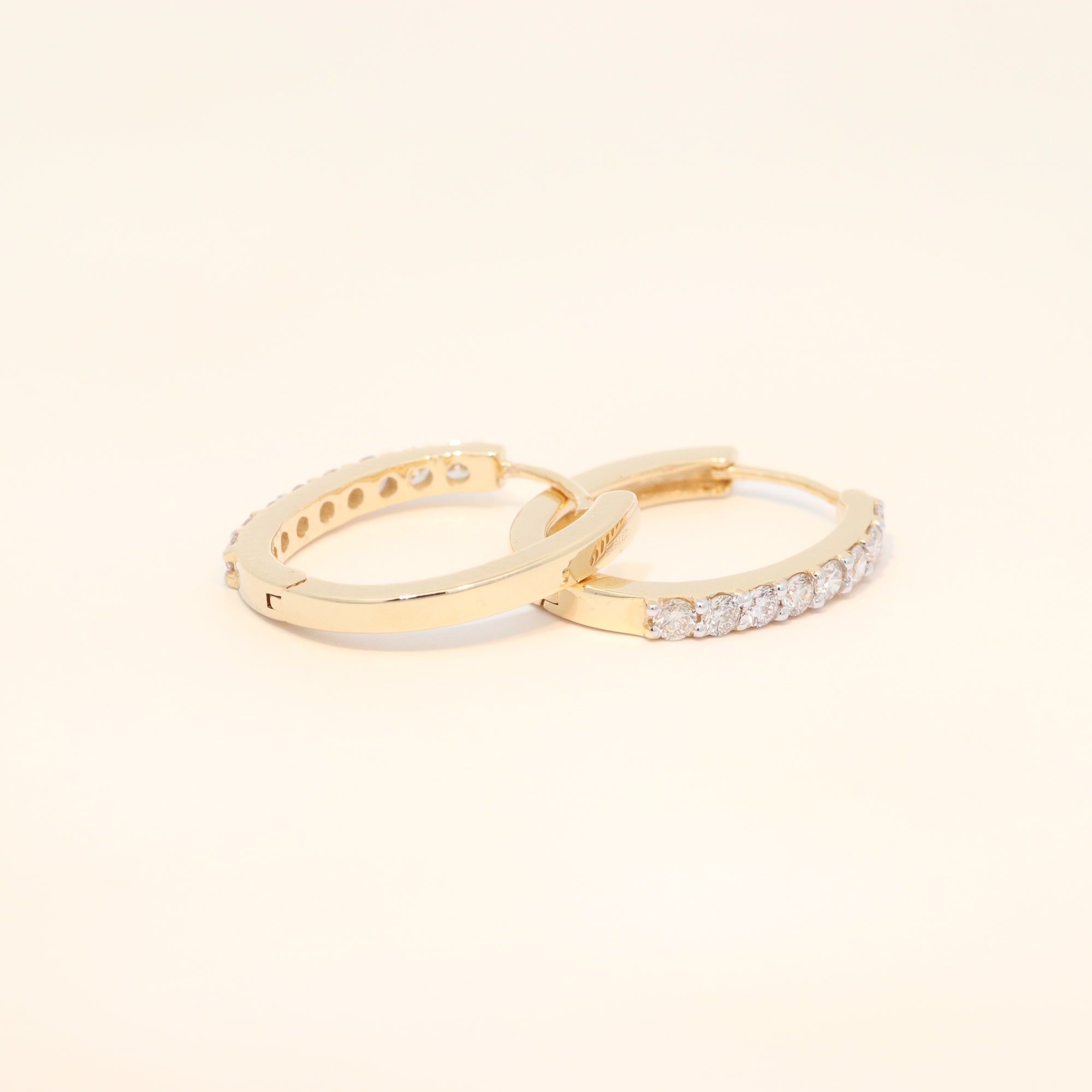 Two gold huggies with natural diamonds.