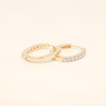 Two gold huggies with natural diamonds.