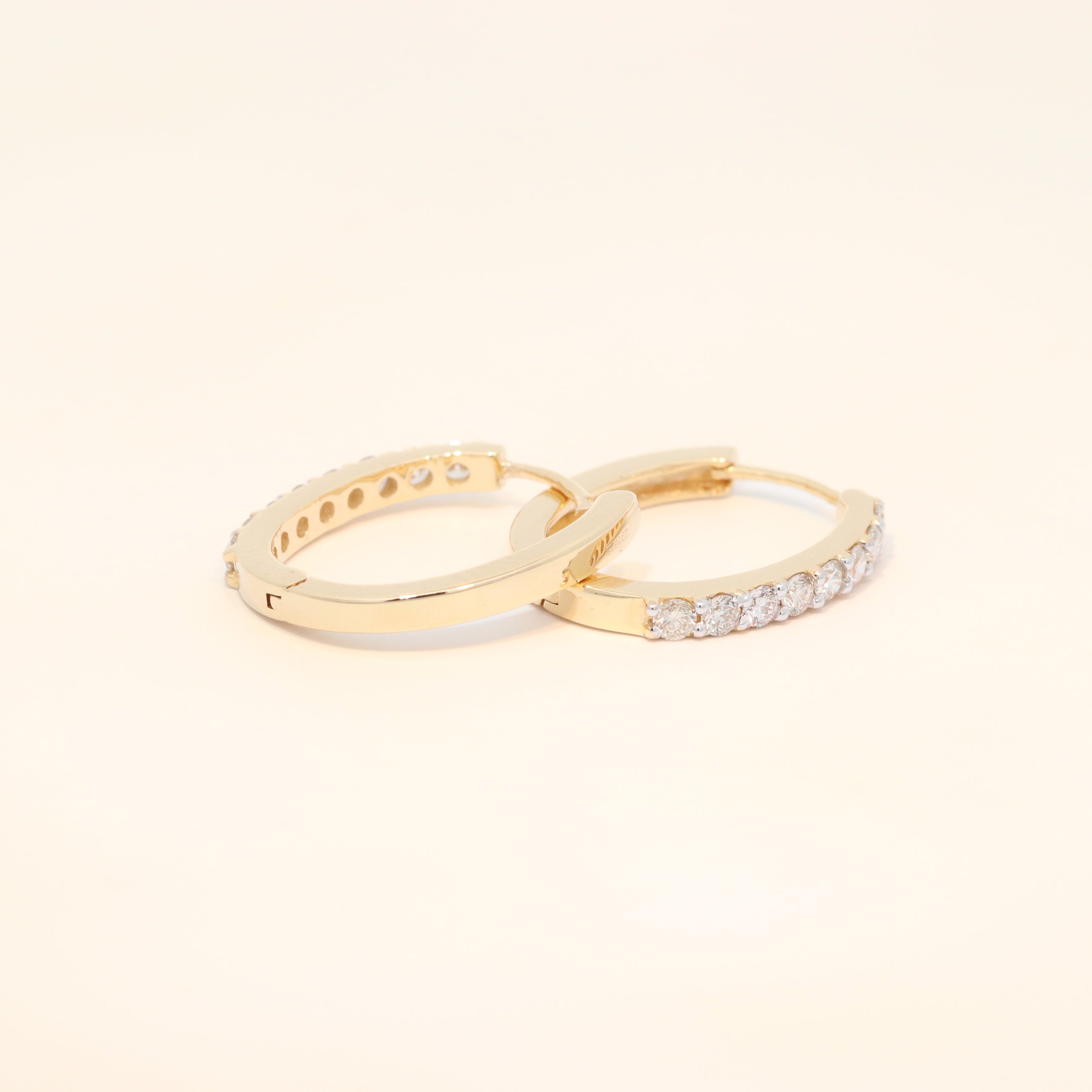 Two gold huggies with natural diamonds.