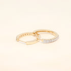 Two gold huggies with diamond accents.