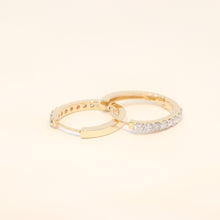 Two gold huggies with diamond accents.