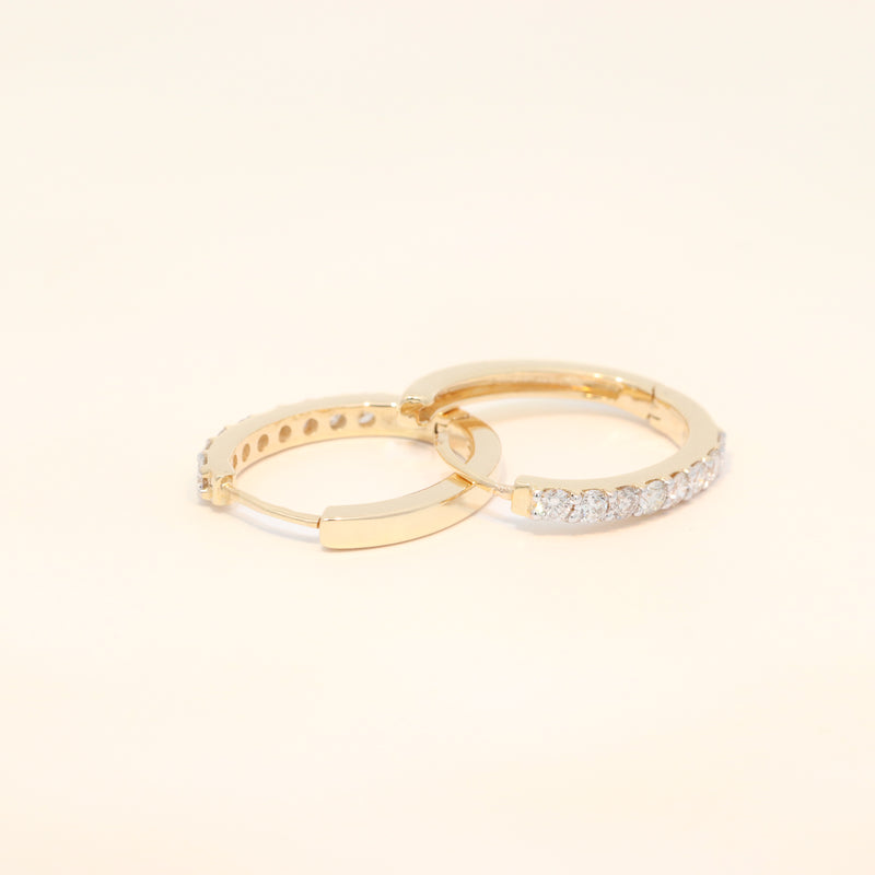 Two gold huggies with diamond accents.