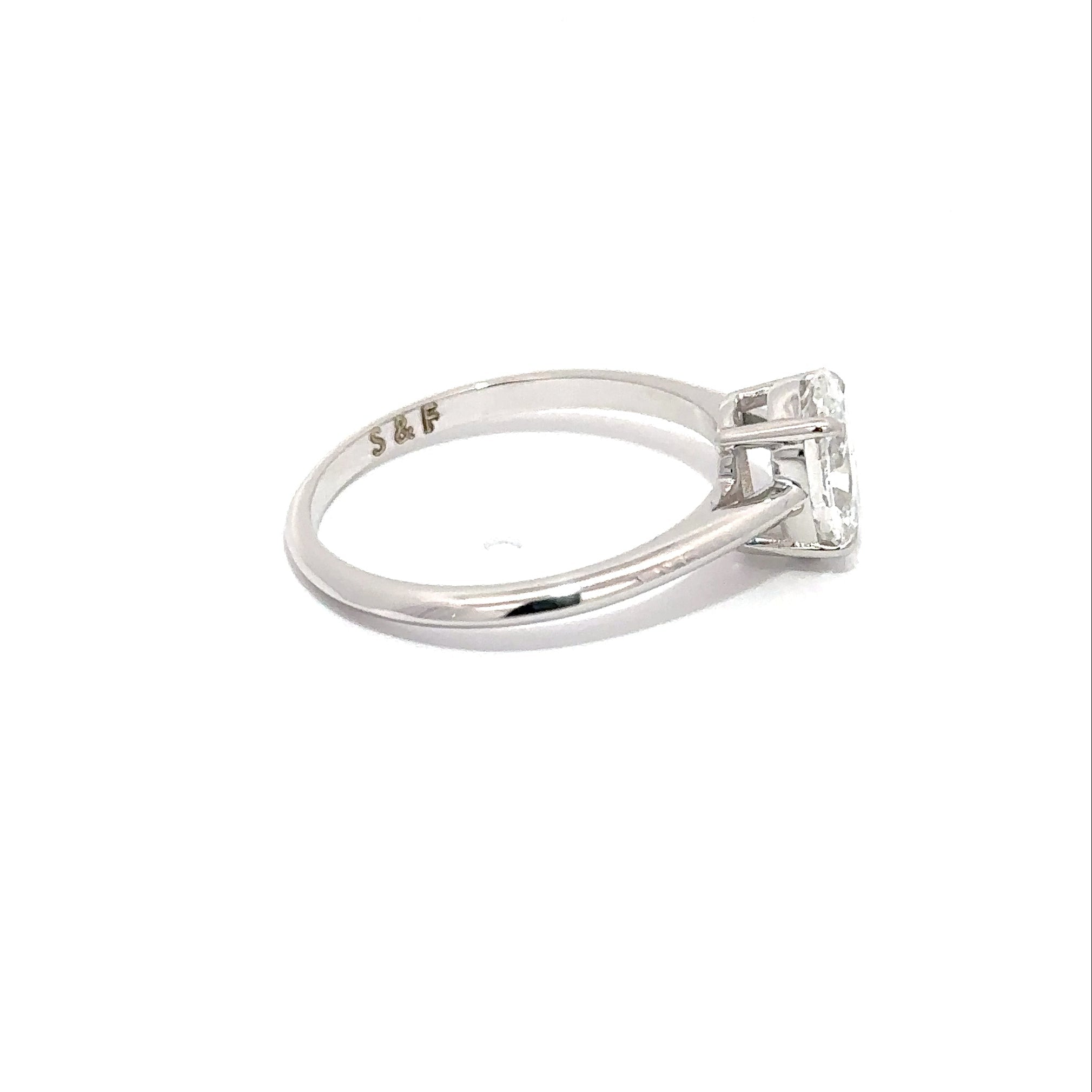 Diamond ring with engraving on a white background