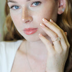 Woman wearing a diamond ring with a blurred background