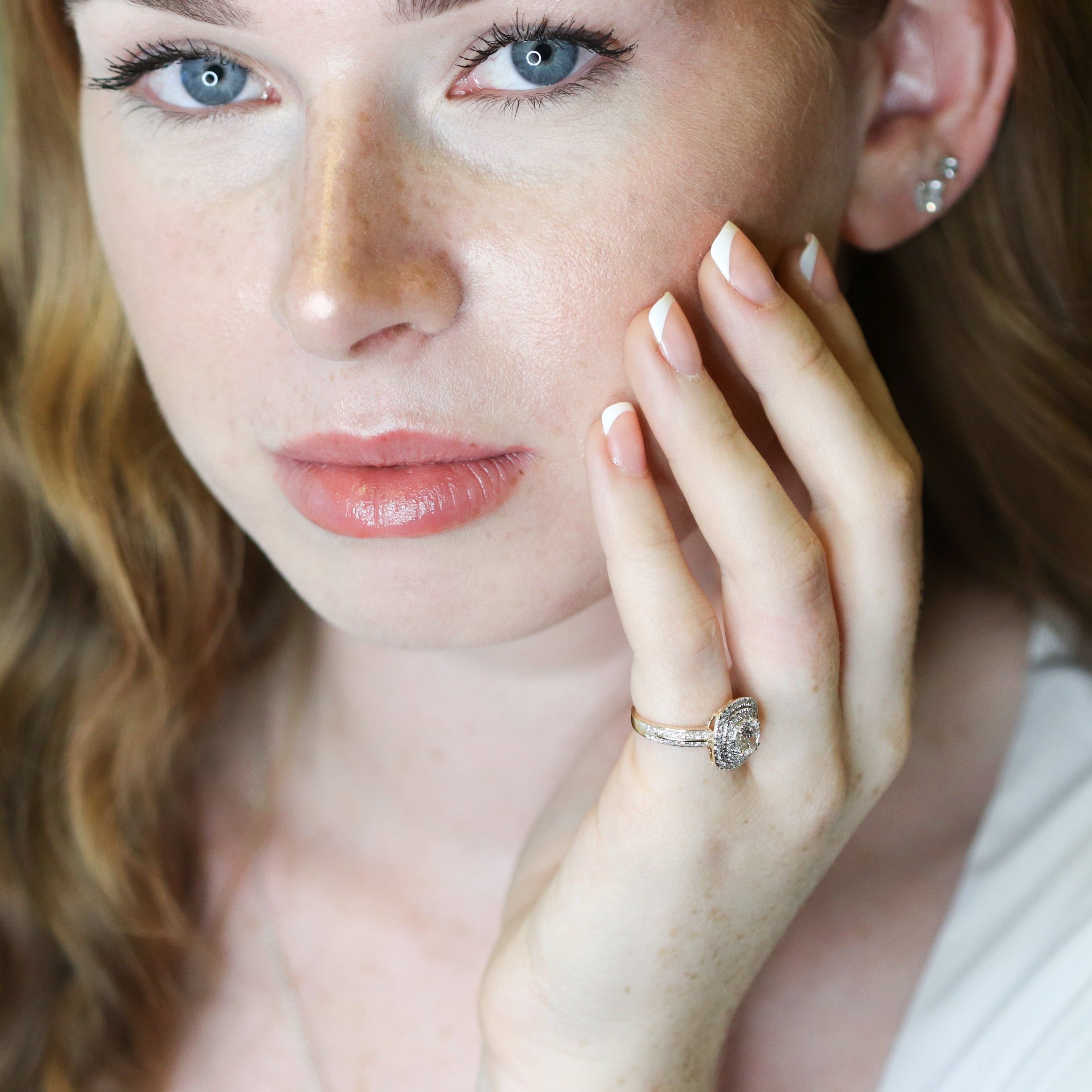 Woman wearing a diamond ring with a soft focus background