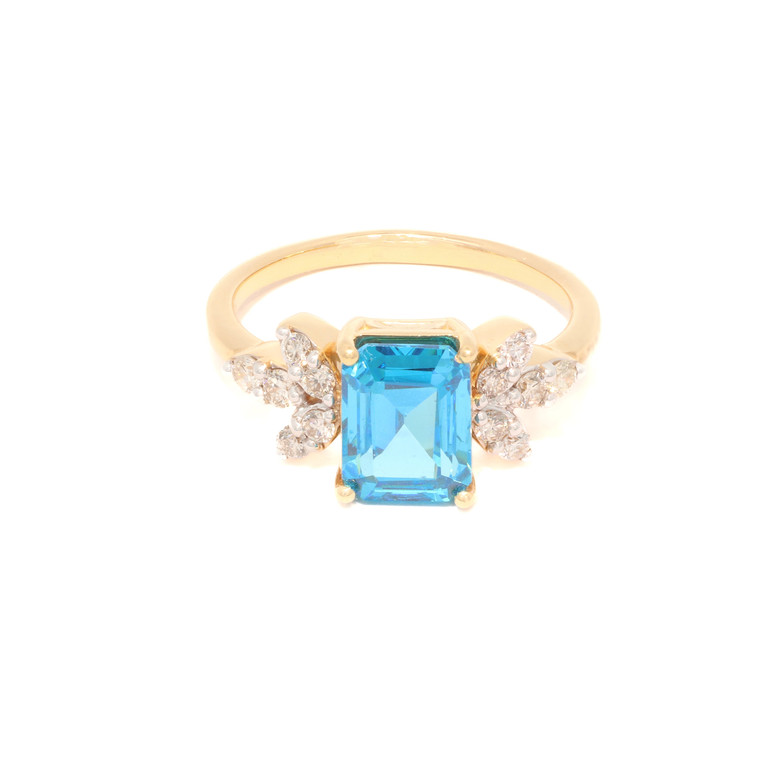 Gold ring with a blue gemstone and diamond accents on a white background