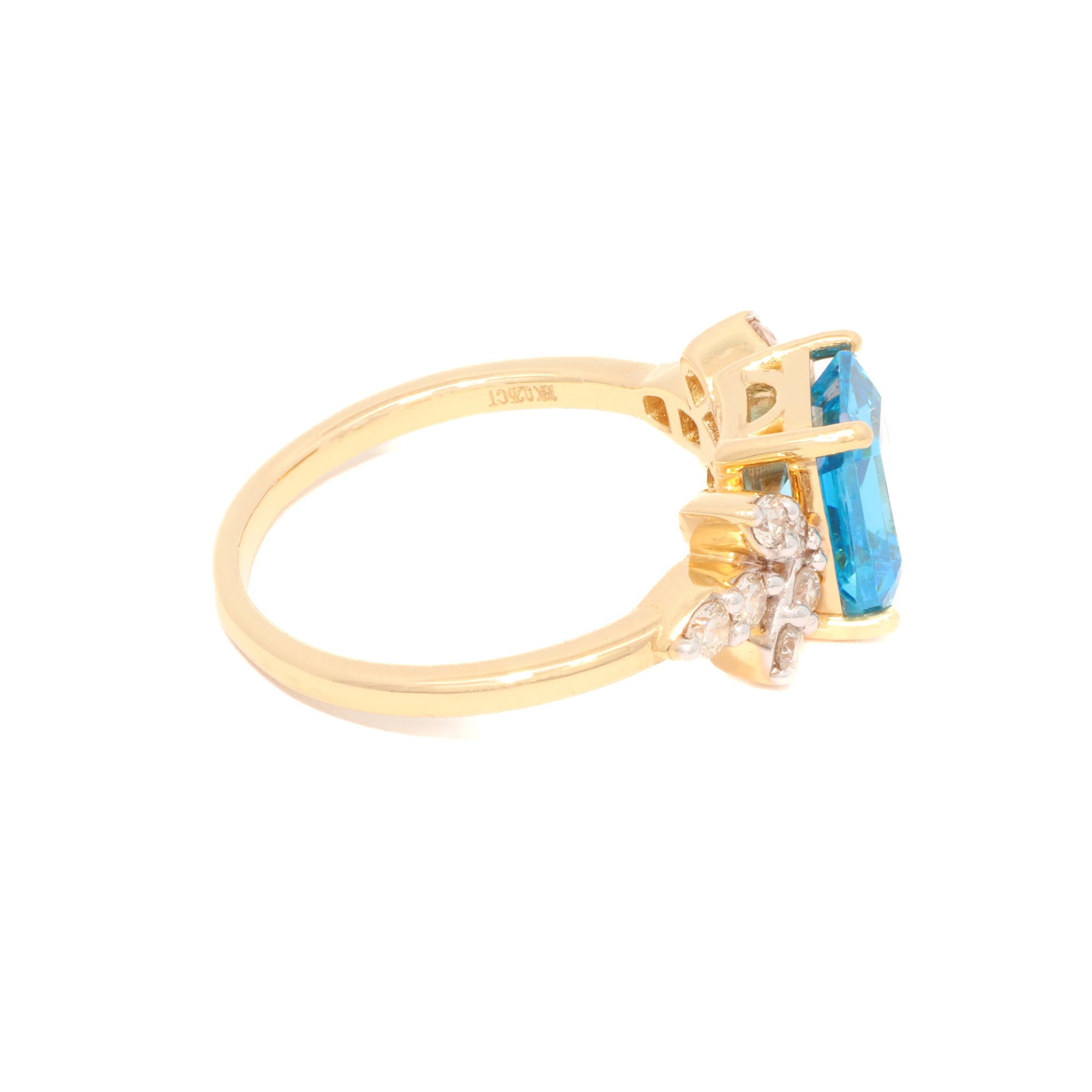 Gold ring with a blue gemstone on a white background
