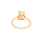 Yellow Gold ring with a radiant diamond on a white background