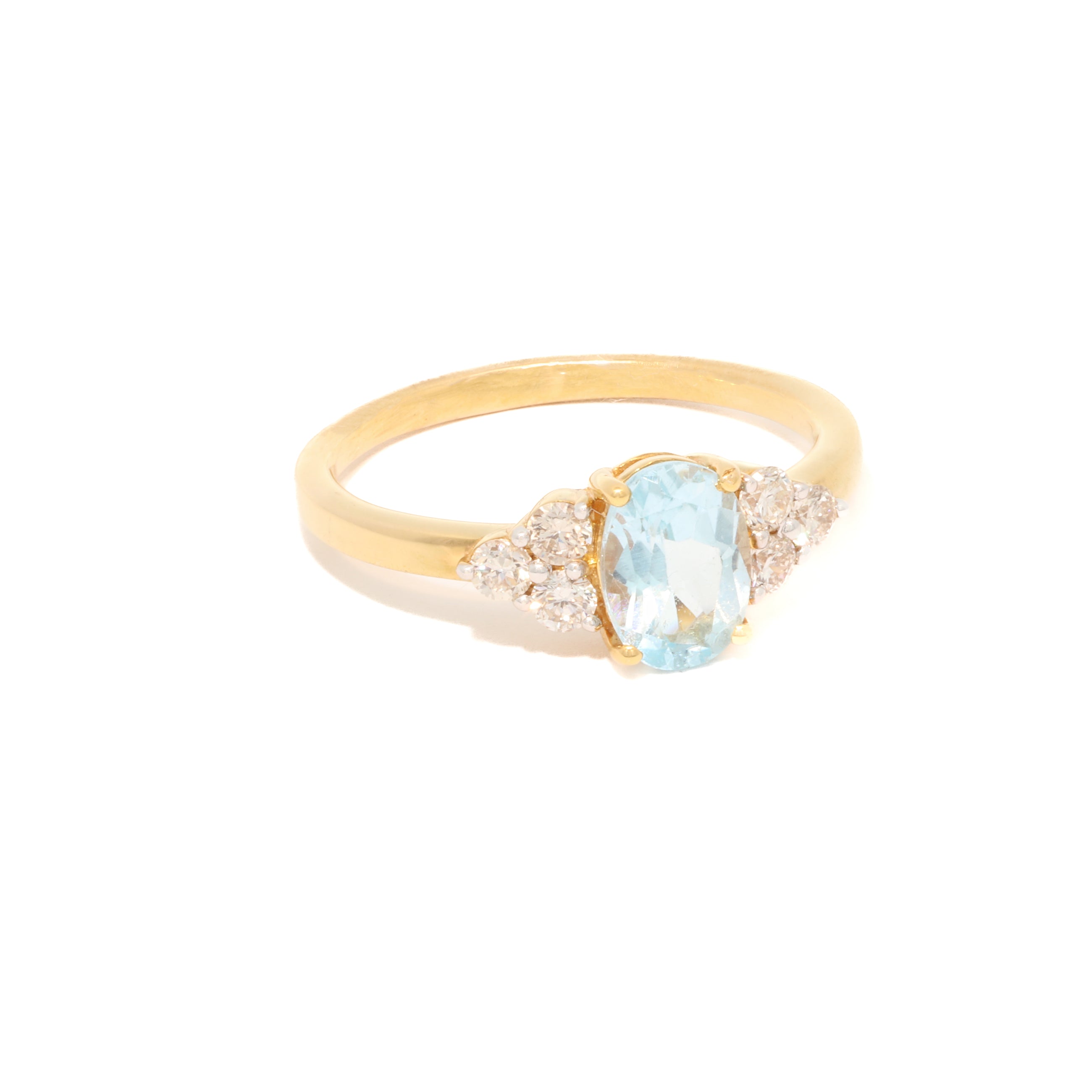 Gold ring with a blue gemstone on a white background