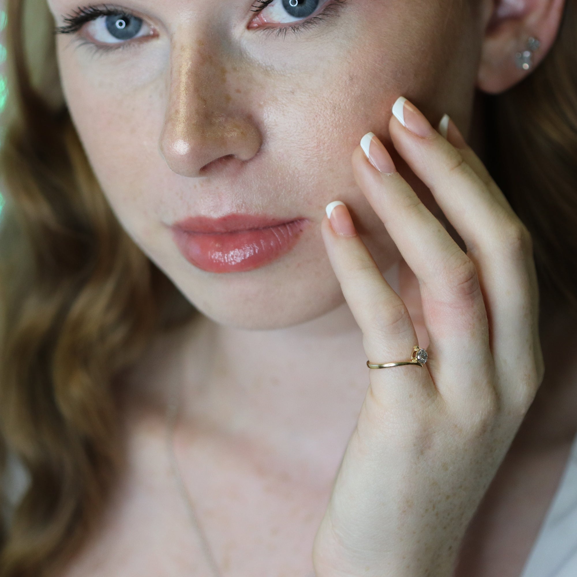 Yellow gold ring with natural diamonds on finger