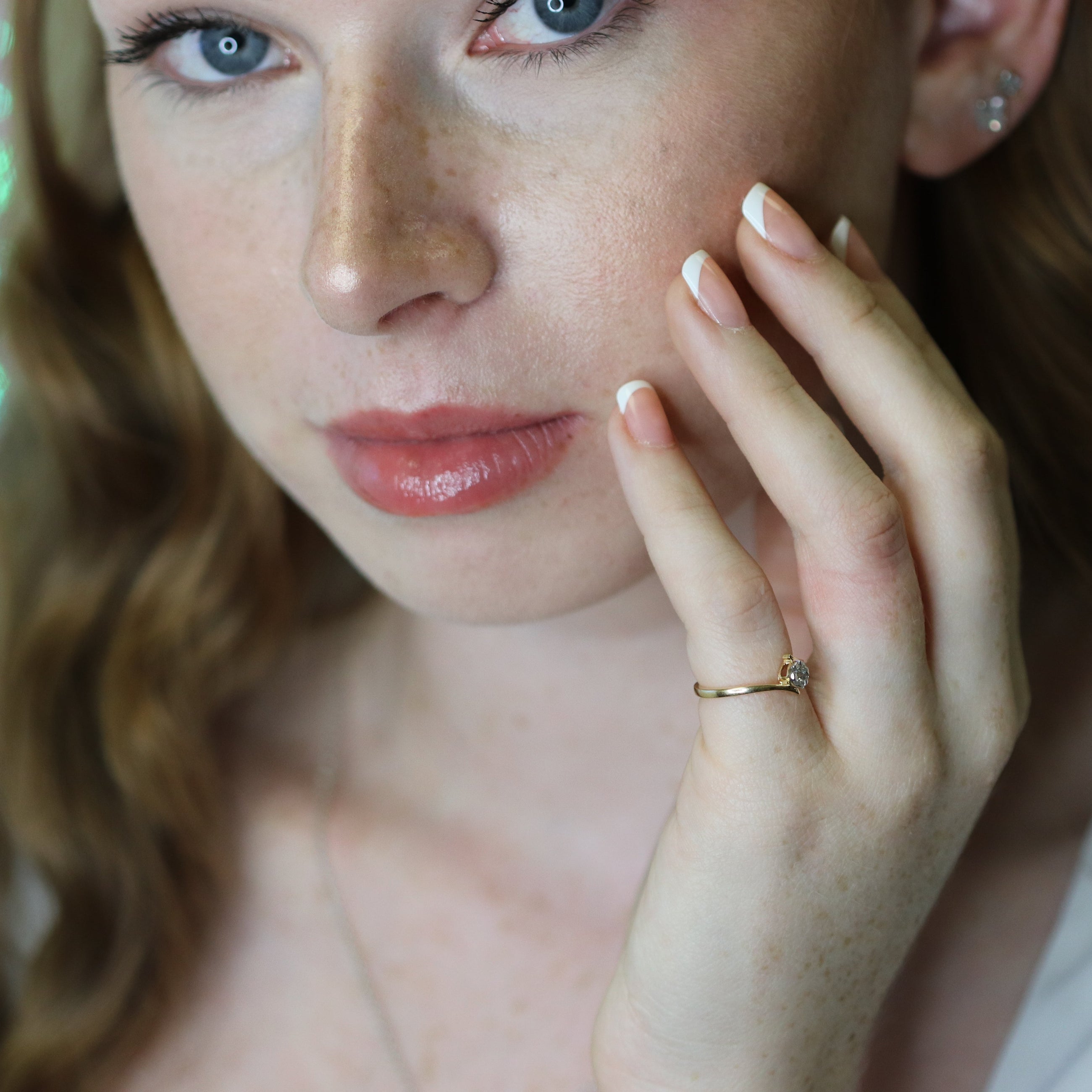 Yellow gold ring with natural diamonds on finger