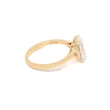 Gold ring with a diamond on a white background